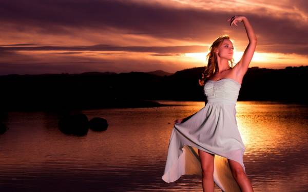 девушка в платье танец на закате солнца возле воды обои для рабочего стола